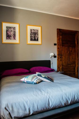 a bed with two pillows on it in a bedroom at Boutique Hotel Al Palazzo Rosso in Neive