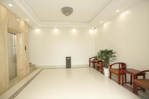 an empty hallway with chairs and a ceiling at MOMALI Hotel Ninh Binh in Ninh Binh