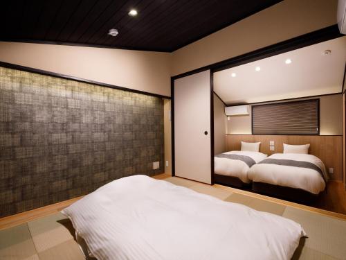 מיטה או מיטות בחדר ב-Kanade Fushimiinari-Taishame