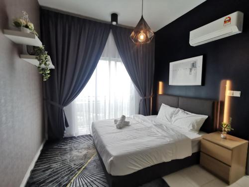 a bedroom with a bed with a teddy bear on it at Ezhome Mesahill in Nilai