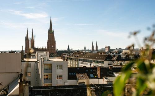 a view of a city skyline with a cathedral at Hotel Nassauer Hof in Wiesbaden