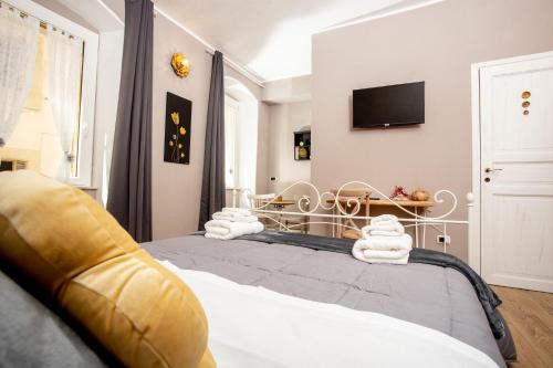 a bedroom with two beds and a tv on the wall at L'Accademia dei Sogni in Sassari