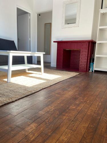 un salon avec une table et une cheminée dans l'établissement François Mitterand, à Elbeuf