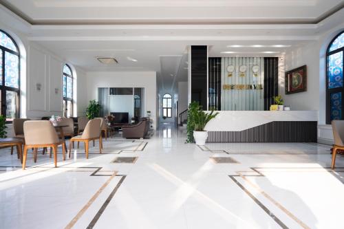 a rendering of a lobby with tables and chairs at Boston Halong Hotel in Ha Long