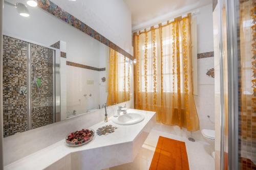 a bathroom with a sink and a mirror at Liberty House (by Vacation Service) in Cefalù