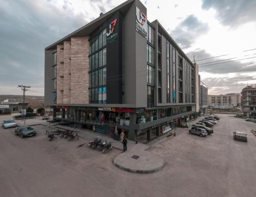 a large building with motorcycles parked in a parking lot at Trivelles Executive Suites Islamabad in Islamabad