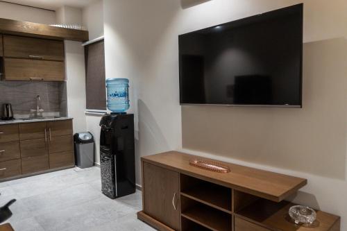 a living room with a large flat screen tv on the wall at Trivelles Executive Suites Islamabad in Islamabad