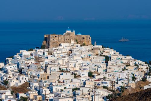 a village on a hill with a castle on top at Astropalia Luxury Studios in Astypalaia Town