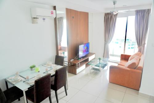 a living room with a table and a couch at Gurney Drive Mansion One Serviced Apartment in George Town