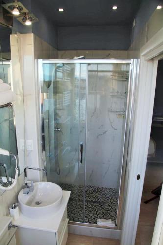 a bathroom with a glass shower and a sink at B&B Pescara Centro Luxury Suite in Pescara
