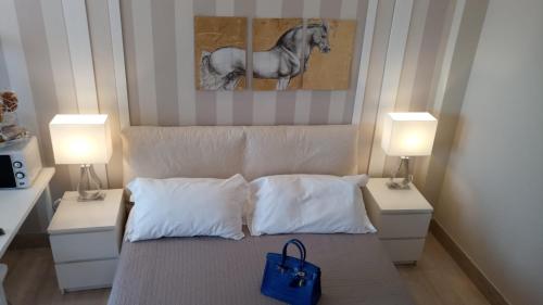 a bedroom with a bed with two night stands and two lamps at B&B Pescara Centro Luxury Suite in Pescara