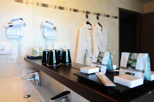 a dressing room with a counter with clothes on display at Logis H&ocirc;tel La Fauceille in Perpignan