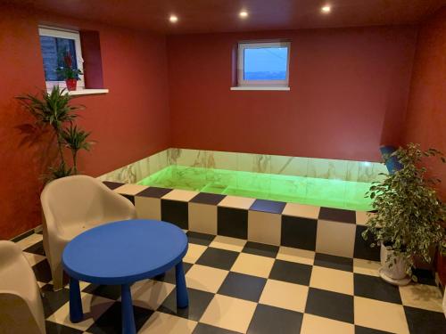 a hot tub in a room with a checkered floor at Very Bad Hootel in Kaunas