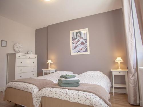 a bedroom with a bed with two tables and two lamps at Chambres & Tables d'hôtes Le Pech Grand in Saint-Sozy