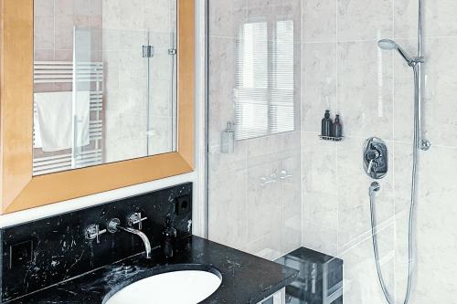 a bathroom with a sink and a shower at Yours Truly in Munich