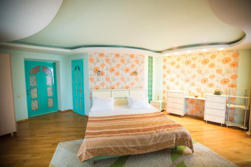 a bedroom with a bed in a room with colorful walls at Home Sweet Home in Chişinău
