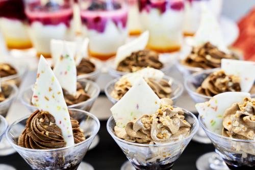 a table topped with cups of ice cream desserts at Globales Cala Viñas Adults Only 16+ in Cala Vinyes