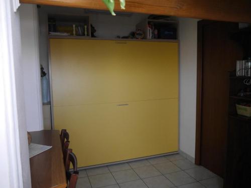 サヴォーナにあるAppartamento Nizzaの黄色いドア付きのクローゼット