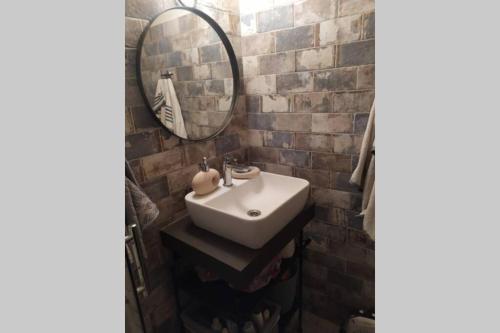 a bathroom with a sink and a mirror at Maro's Guesthouse in Agios Lavredios
