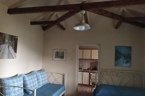 a living room with a bed and a kitchen at Maro's Guesthouse in Agios Lavredios