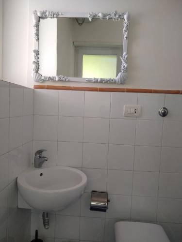 a bathroom with a sink and a mirror at Soleluna in Capri