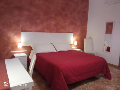a hotel room with a bed and two lamps at Bed & Breakfast Fontanarossa Airport in Catania