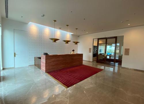 a lobby with a reception desk and a red rug at Marasa Sarovar Premiere, Bodhgaya in Bodh Gaya