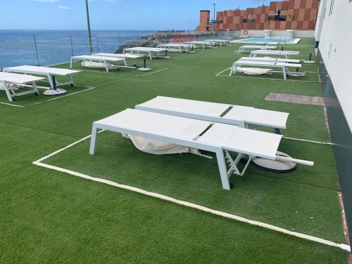 a row of white picnic tables on a roof at Beyond Amadores C&H Suite in Amadores