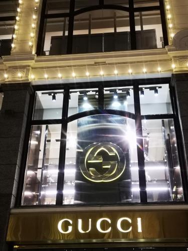 a close up of a gucci sign in a store window at First Hotel Millennium in Oslo