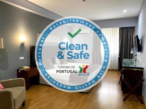 a sign for a clean and safe sign in a living room at Hotel Onix in Viseu