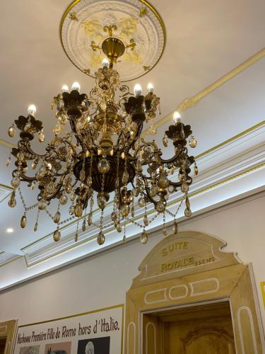 a chandelier hanging from a ceiling in a building at Suite Royale Maison de l'église du couvent in Narbonne
