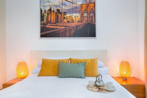 a bedroom with a bed with two lamps at Stay U-nique Apartments Balmes in Barcelona