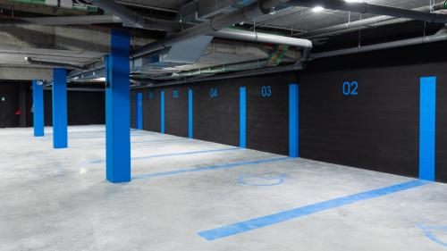 a parking lot with blue columns in a parking garage at Ibis Budget Bilbao City in Bilbao