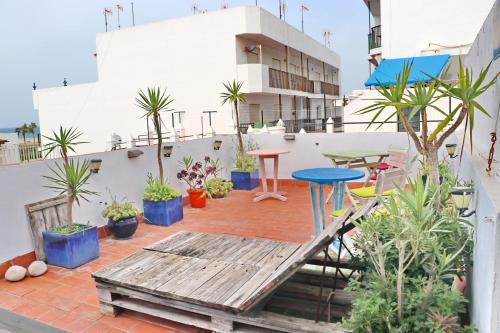 balcón con mesa y macetas en Habitación Cañaveral Playa Conil II, en Conil de la Frontera