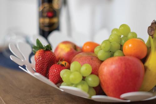 a bowl of fruit on a wooden table at Szépasszony Fogadó in Eger