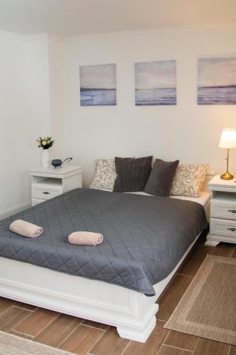 a bedroom with a bed with two pillows on it at Szépasszony Fogadó in Eger