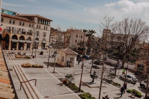 a city street with a statue and buildings at Le Beach in Saint-Tropez