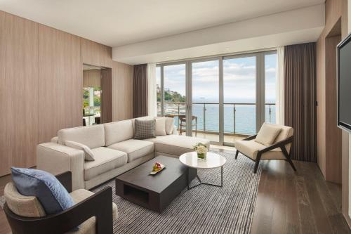 a living room with a couch and a table at Intercontinental Shenzhen Dameisha Resort by IHG in Shenzhen