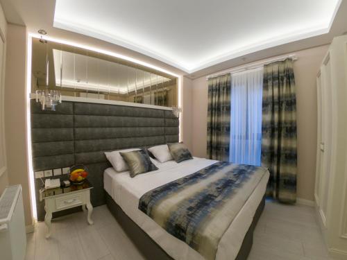 a bedroom with a large bed and a large window at Crowned Hotel in Istanbul