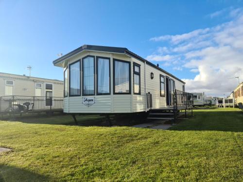 a tiny house sitting on the grass in a yard at Fantasy Lodge Sunnymede in Ingoldmells