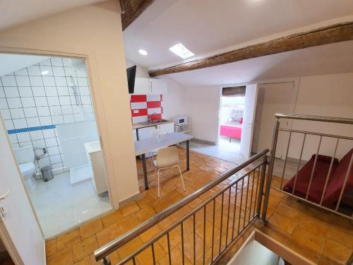 a room with a staircase and a table in a room at APPARTEMENT AGATHOIS-3 in Agde