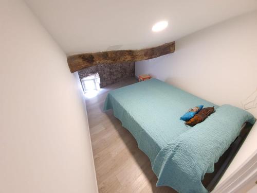 a bedroom with a green bed in a attic at APPARTEMENT AGATHOIS-3 in Agde