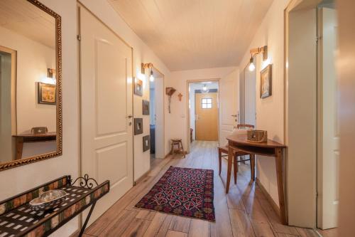 a hallway with a table and a mirror at Alpen-Apartment Neustift in Neustift im Stubaital