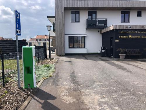 a building with a green sign in front of it at Hotel Rooms in Breskens