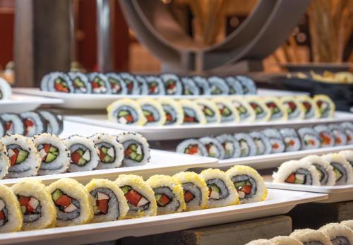 a row of plates of sushi on display at Serenity Alma Heights - Ex Serenity Fun City in Hurghada