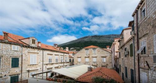 a group of buildings with a mountain in the background at Old Town Budget in Dubrovnik