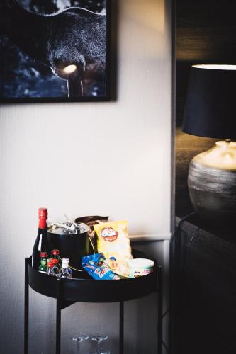 a table with food and drinks on it next to a lamp at Hotell Östersund in Östersund