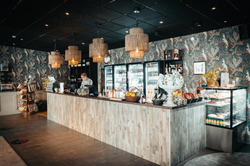 a bar in a restaurant with a man behind the counter at Hotell Östersund in Östersund