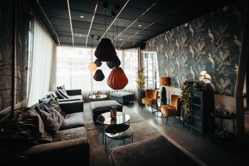 a living room with a couch and a table at Hotell Östersund in Östersund