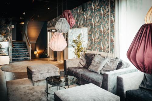 a living room with a couch and a table at Hotell Östersund in Östersund